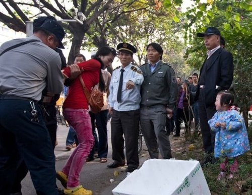 城管與女小販發(fā)生沖突后，女小販被警方強(qiáng)行帶走，她的孩子在一旁放聲大哭。南都記者 黎湛均 攝